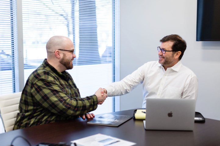 Andy shaking hands with a client